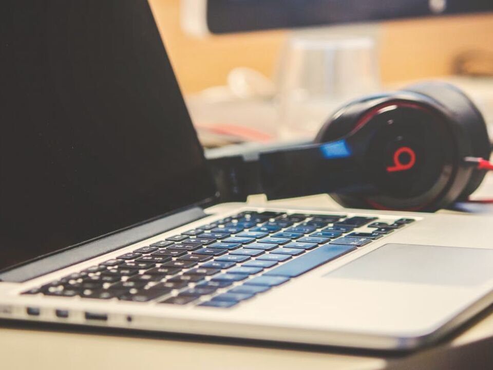 Headphones resting on a laptop