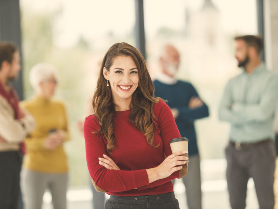 A woman standing confidently in an office