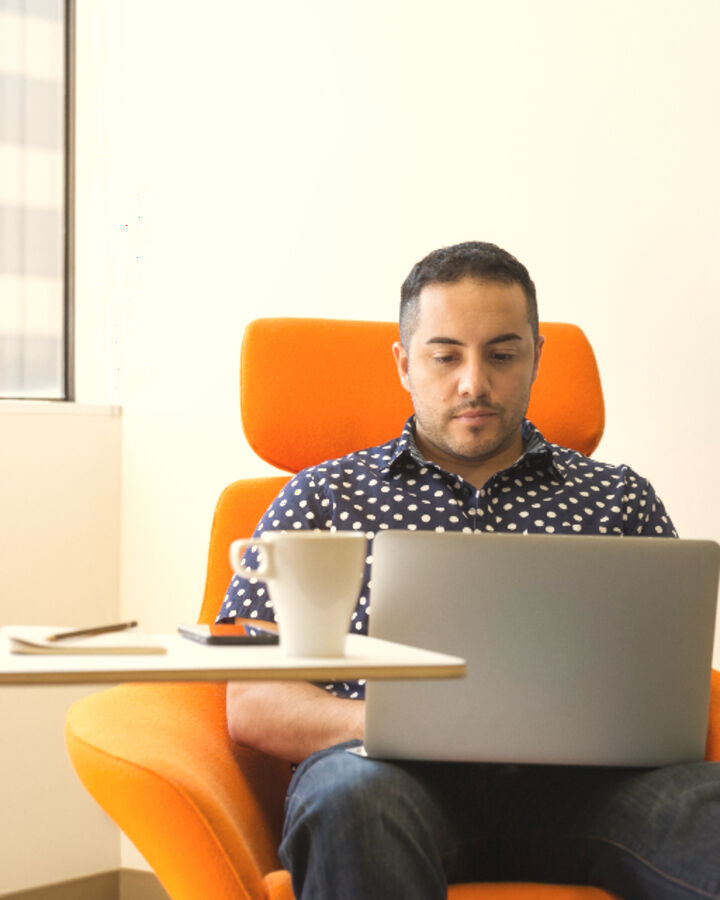 A person on a video call at a laptop